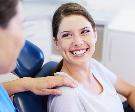 smiling woman sitting in a dental chair