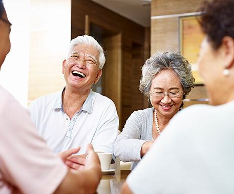 elderly asian couple laughing together