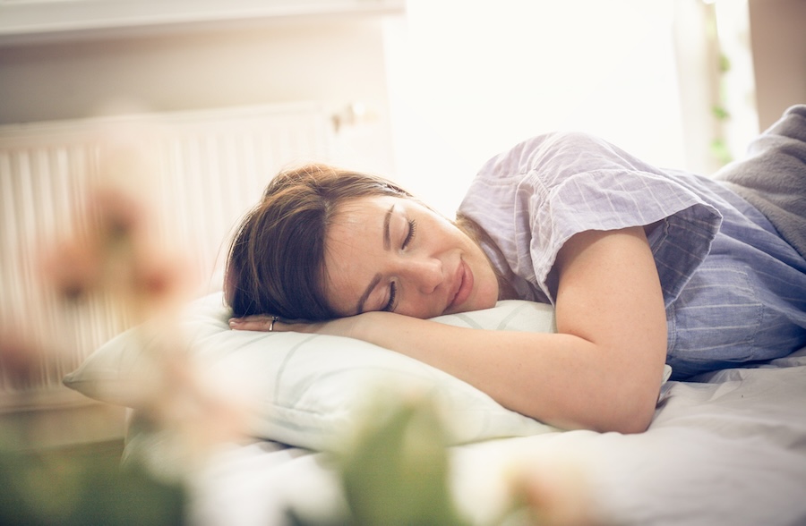 woman resting after tooth extraction, tooth extraction aftercare